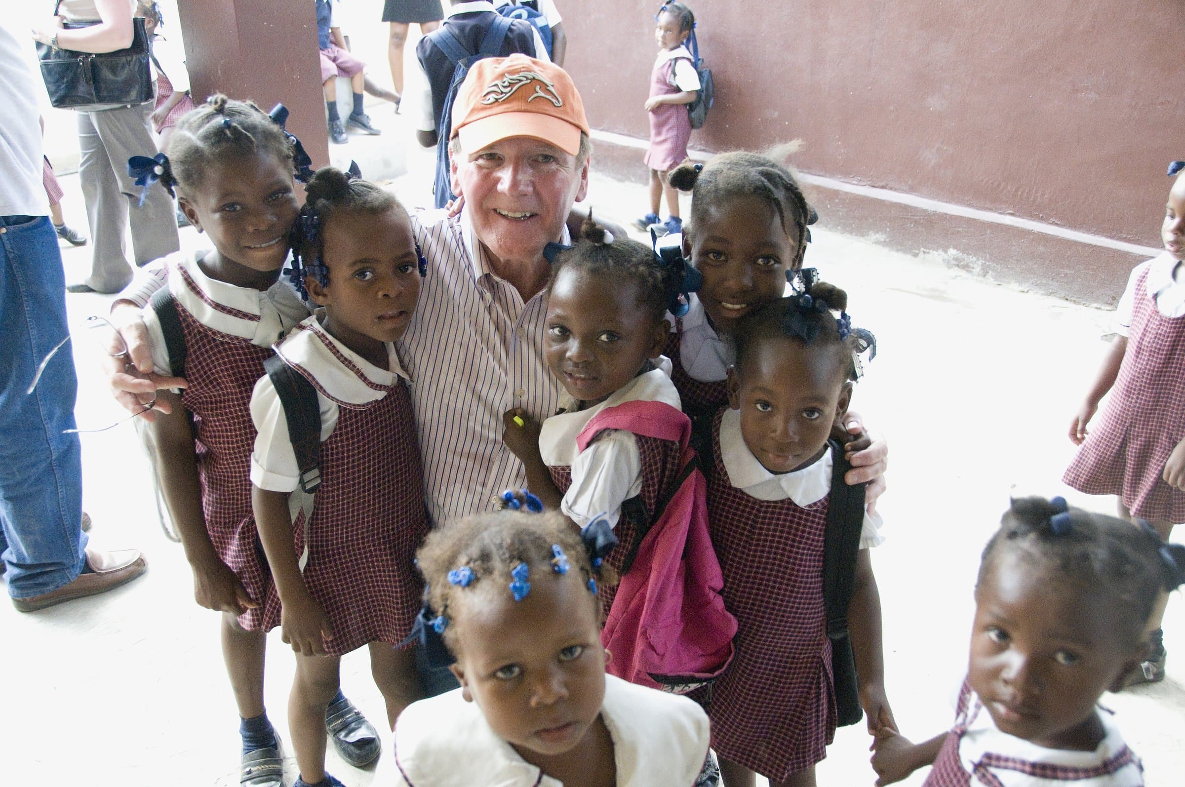 Dr. Pearse Lyons surrounded by schoolchildren in Haiti